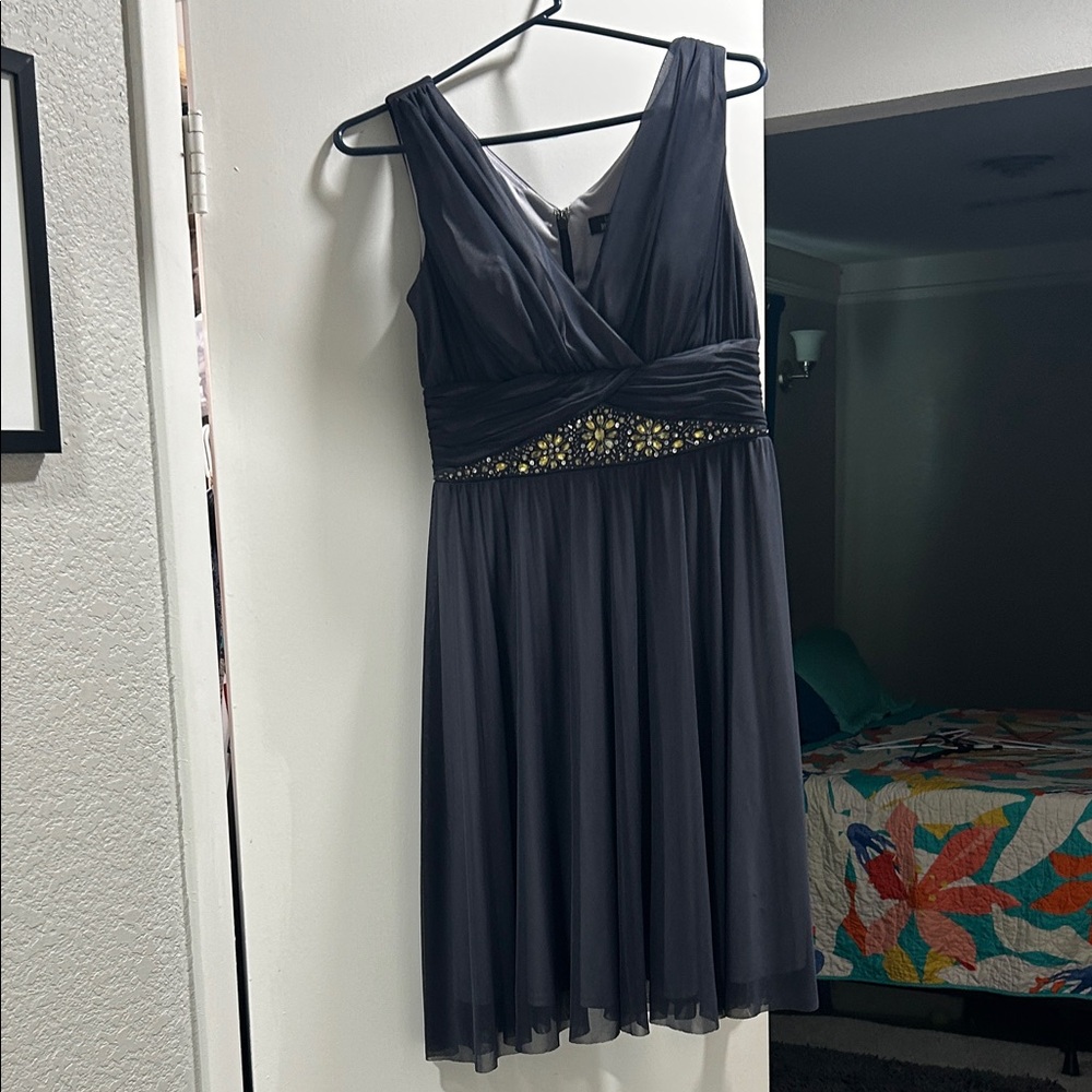 Chic Black Sleeveless Midi Dress with Embellished Waist